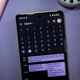 A photo of a phone showing Google Calendar in the month of March